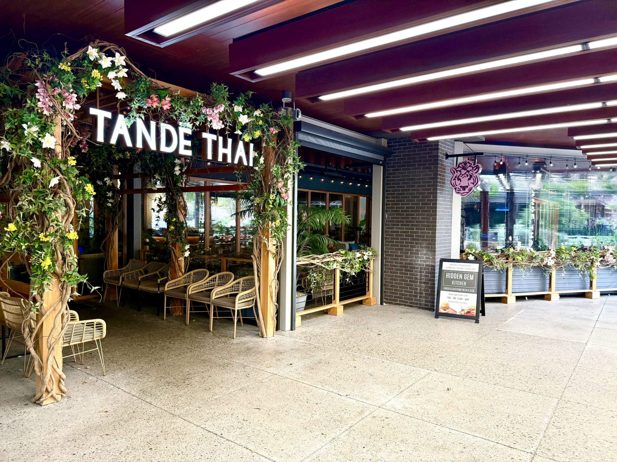 Tande Thai entrance across from Downward Dog Puppy Yoga at Grandscape