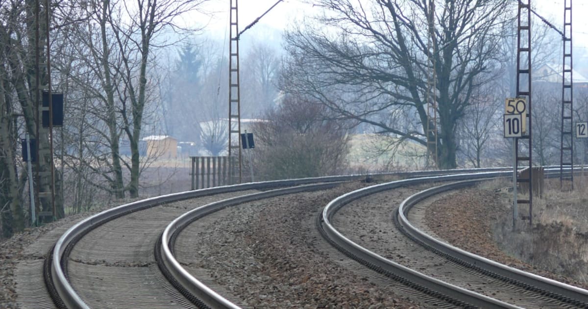 Railway tracks curving through a junction where multiple lines converge and switch