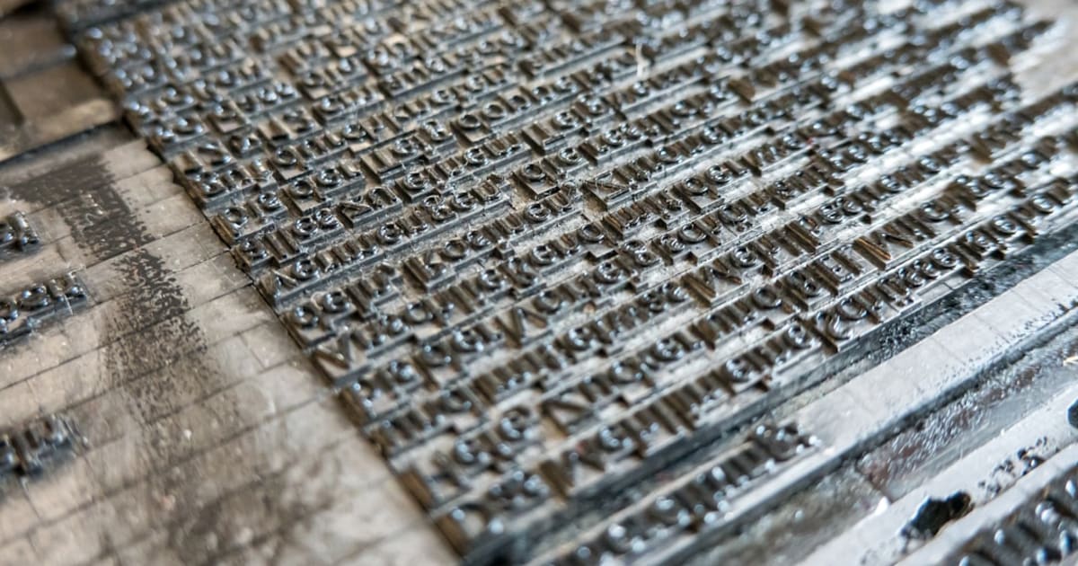 Rows of metal letterpress type arranged in a printing form, representing the deliberate document design Craft is known for