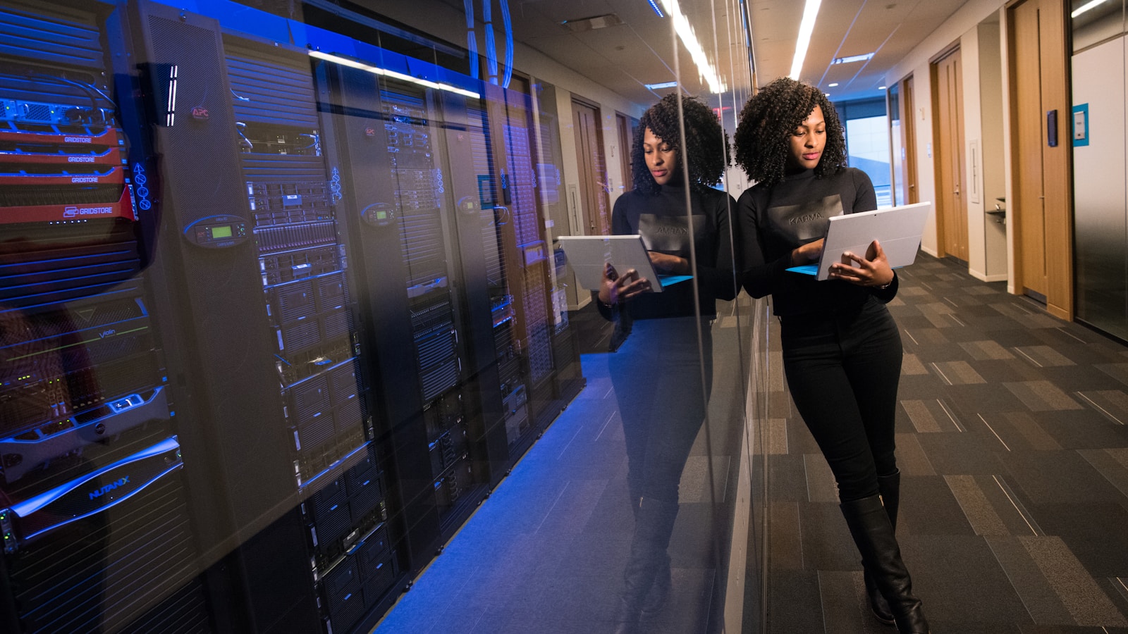 People walking through a modern server room