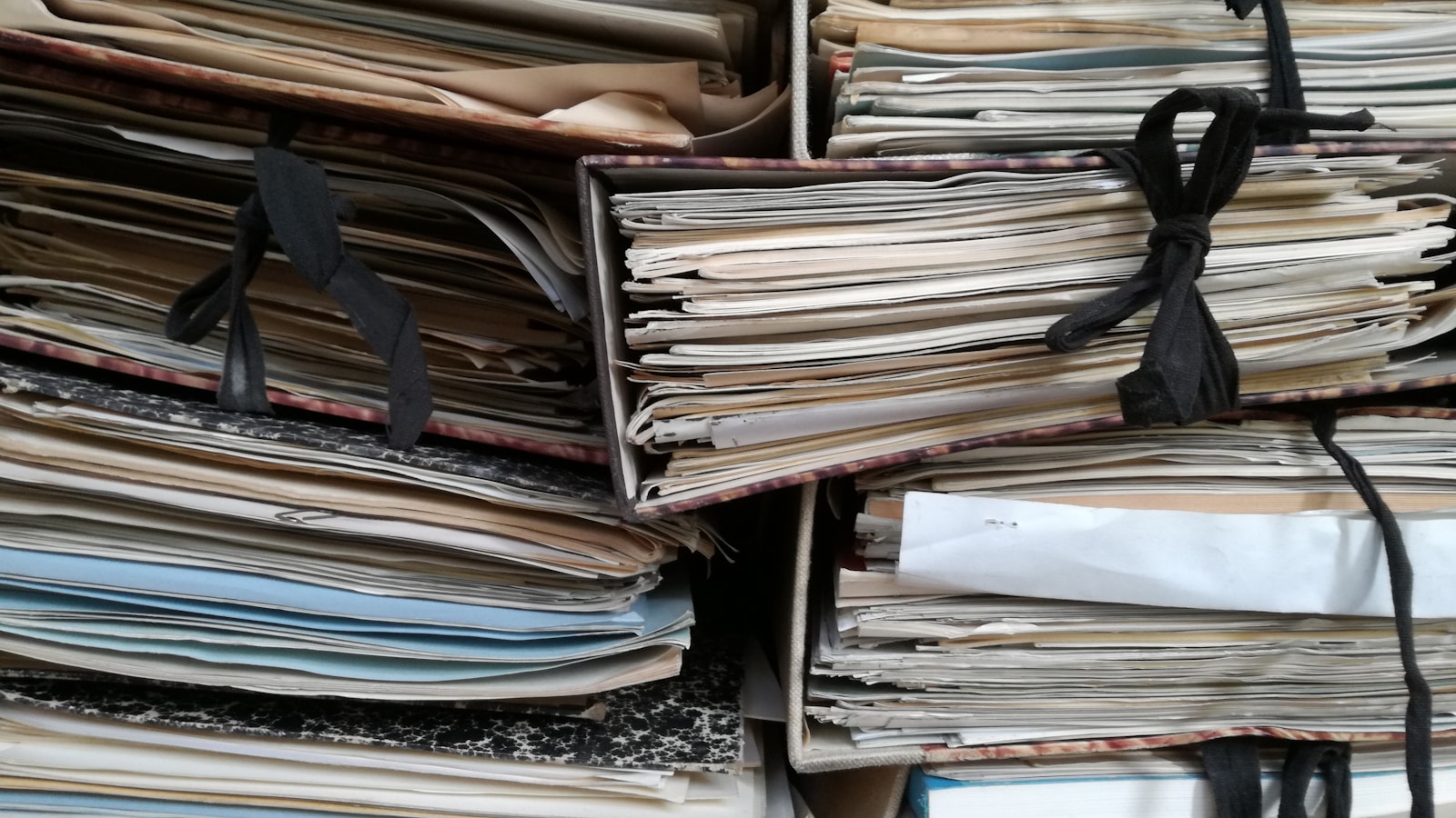 Stack of tied paper files and documents