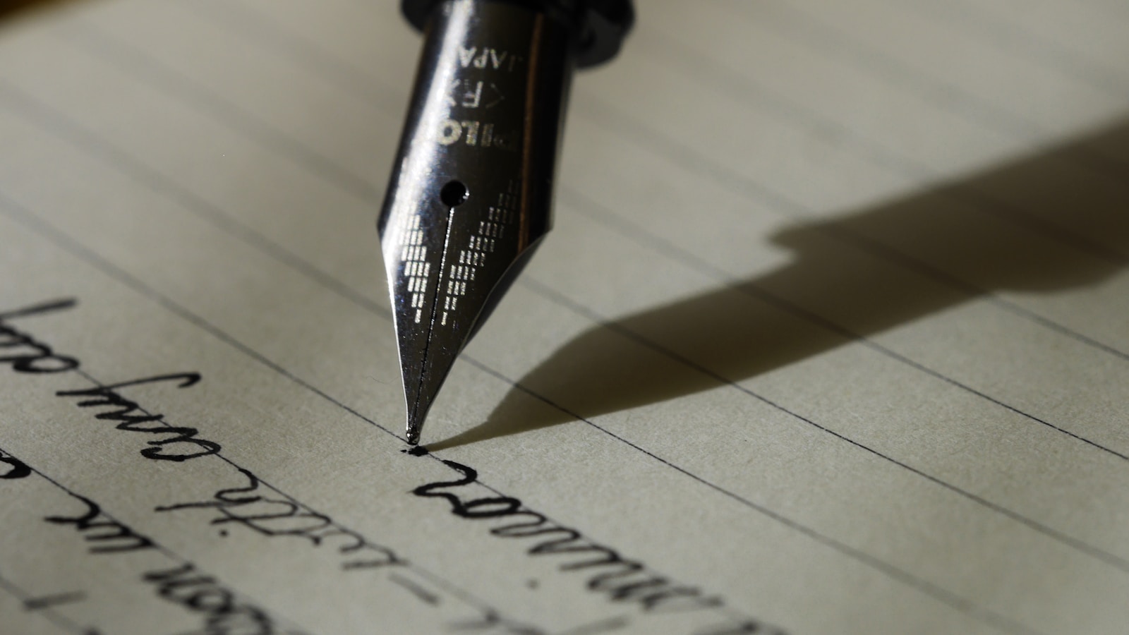 Fountain pen writing in a lined notebook