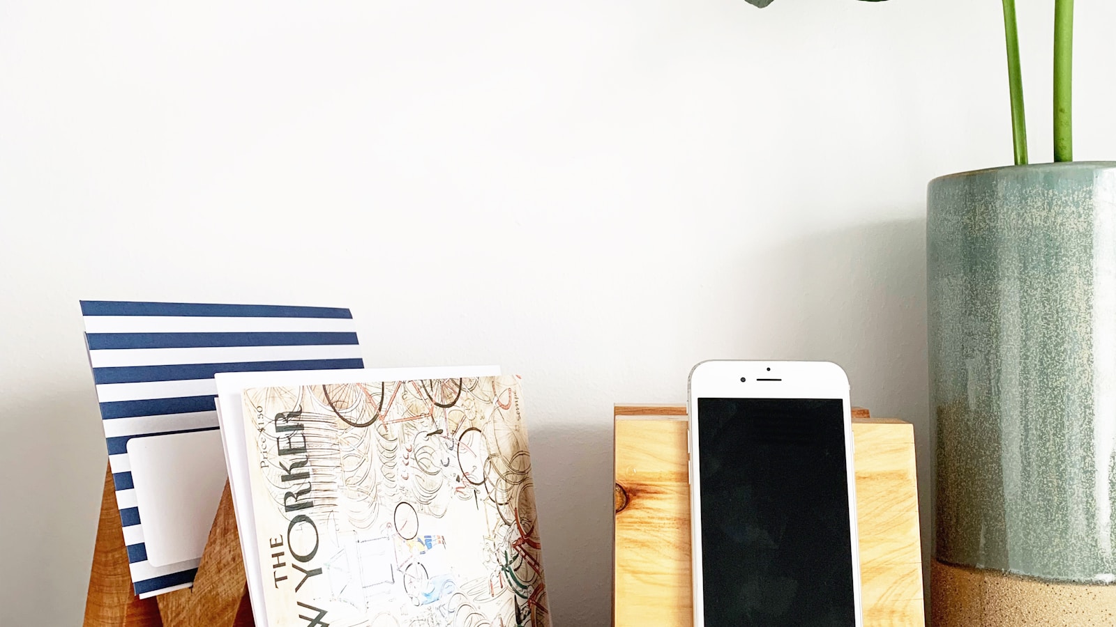 Phone and notebook arranged on a minimal shelf