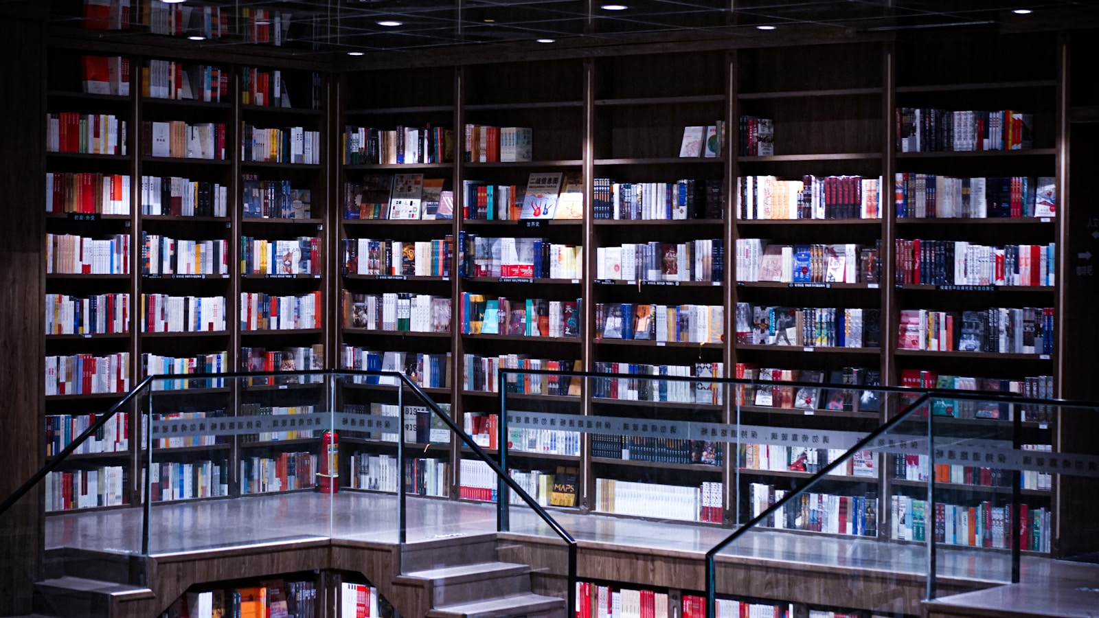 Large library with rows of books and reading tables