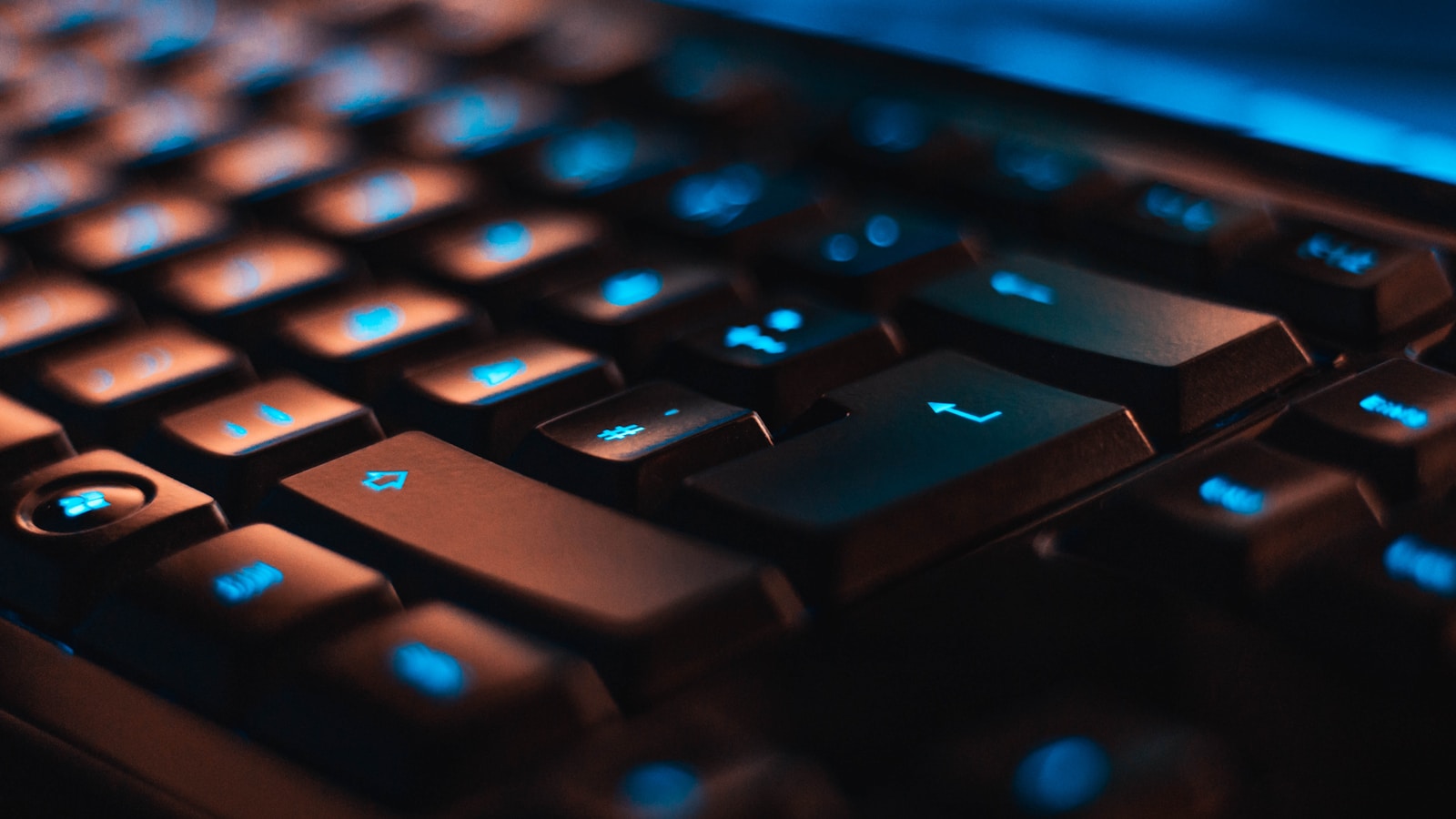 Backlit mechanical keyboard in a dark workspace