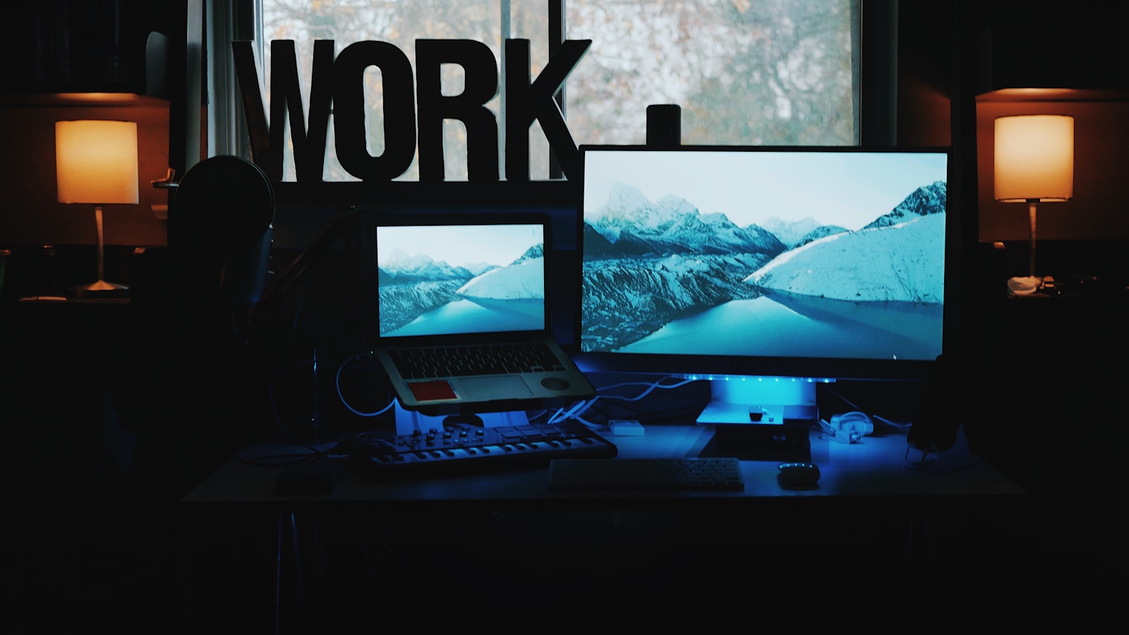 Dark multi-monitor workstation used for focused work