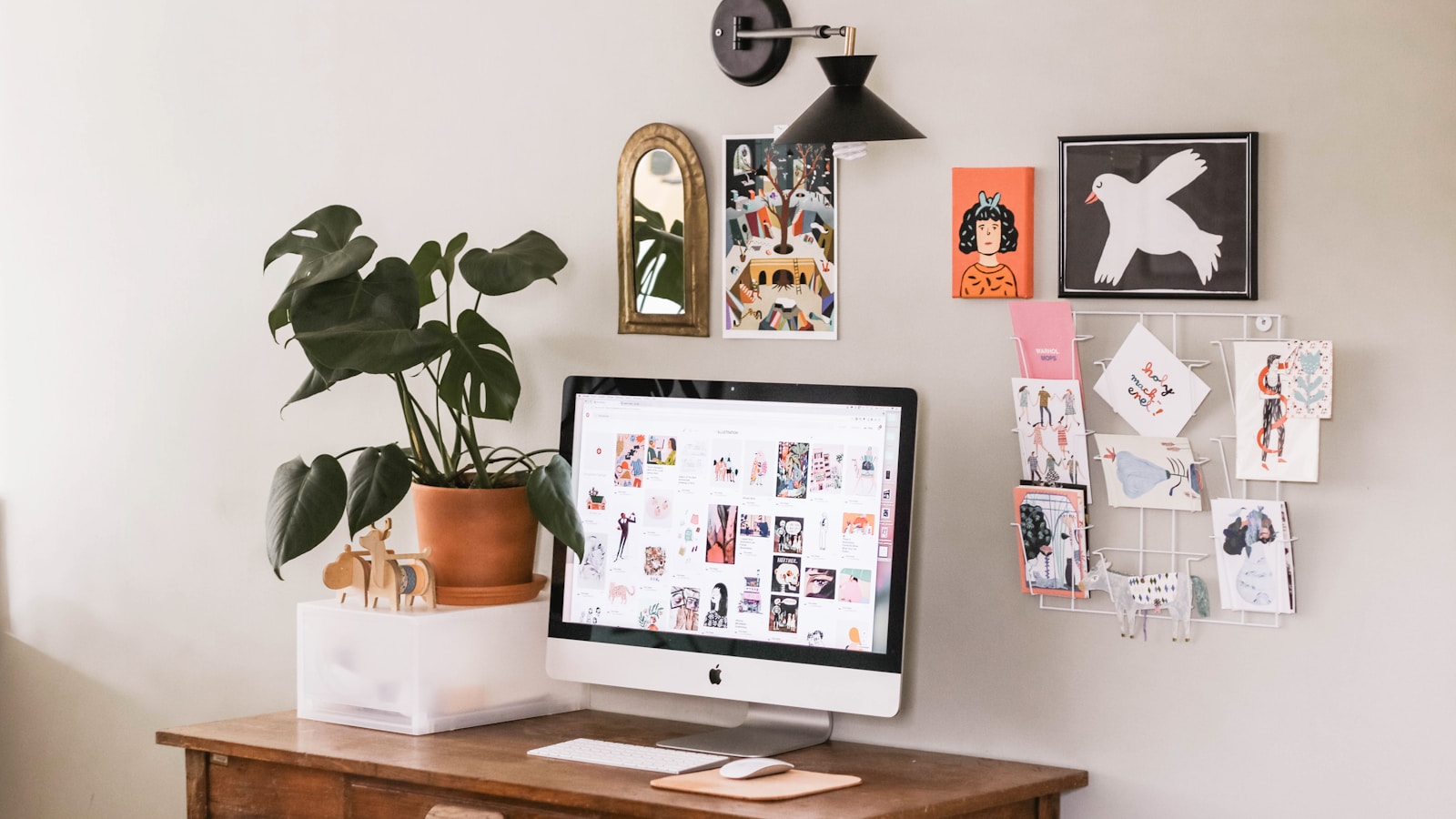 Creative home workspace with computer, plants, and pinned references