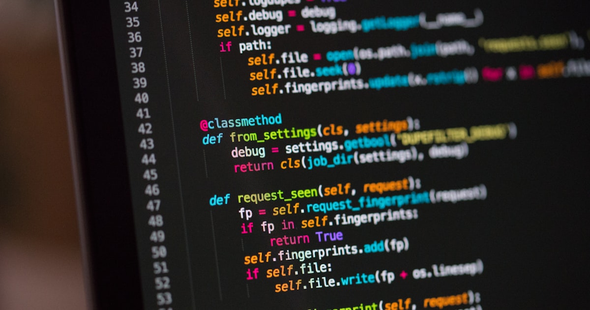Laptop screen showing code editor with syntax highlighting