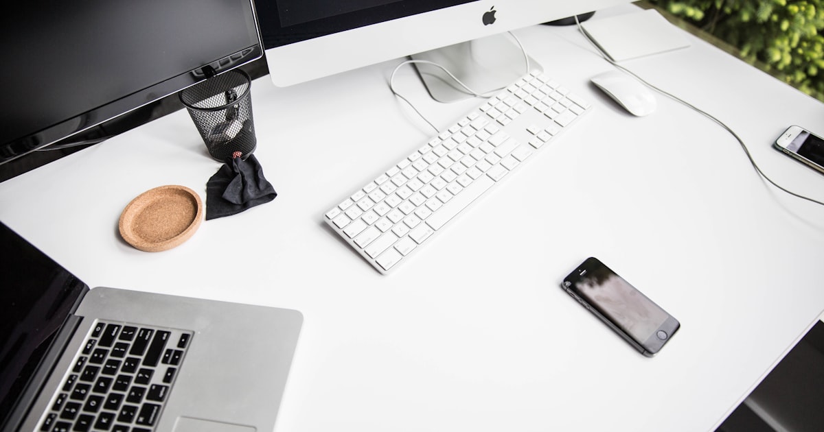Minimal startup desk with laptop and notebook