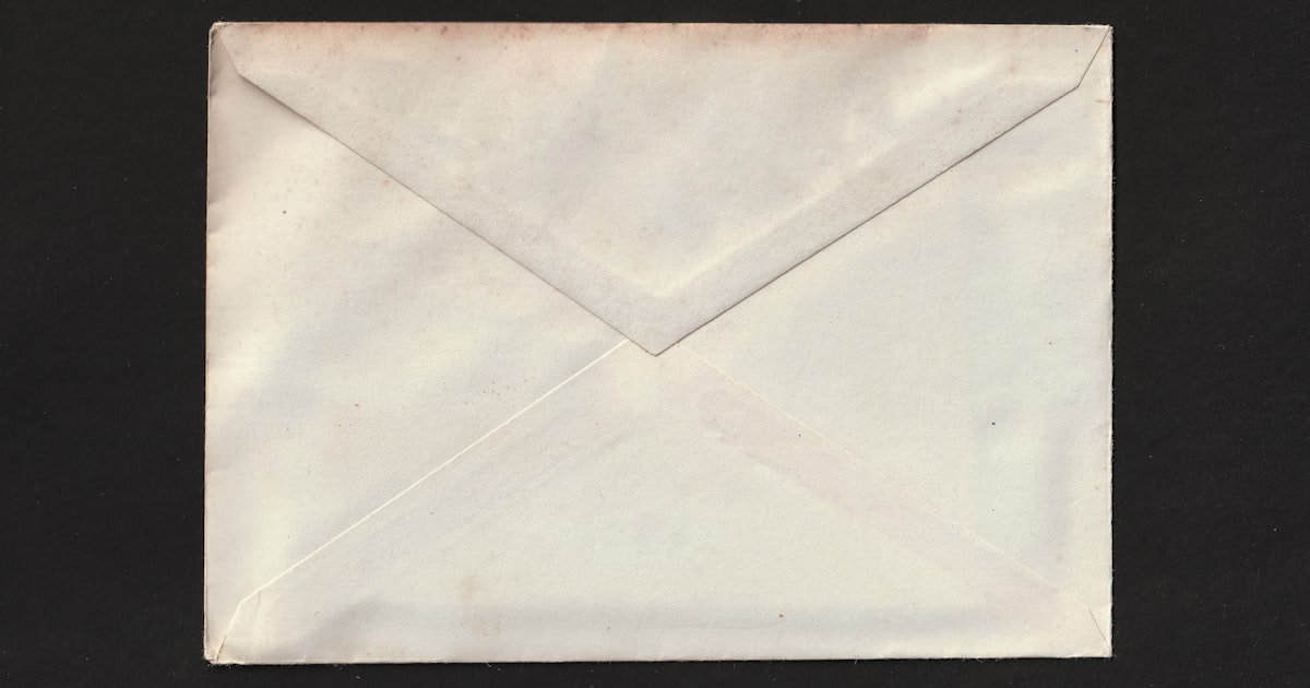 Paper envelope on a clean desk representing email delivery