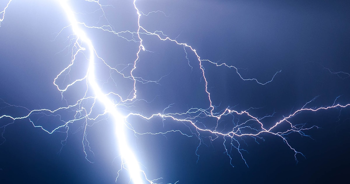 Lightning bolt over a dark cityscape representing speed