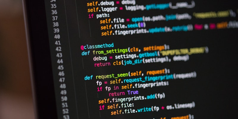 Developer typing on a keyboard with code visible on screen