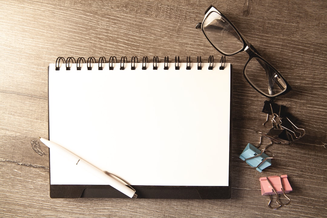 Simple paper checklist and pen on a wooden surface, representing a task manager you pay for once rather than renting access to every month