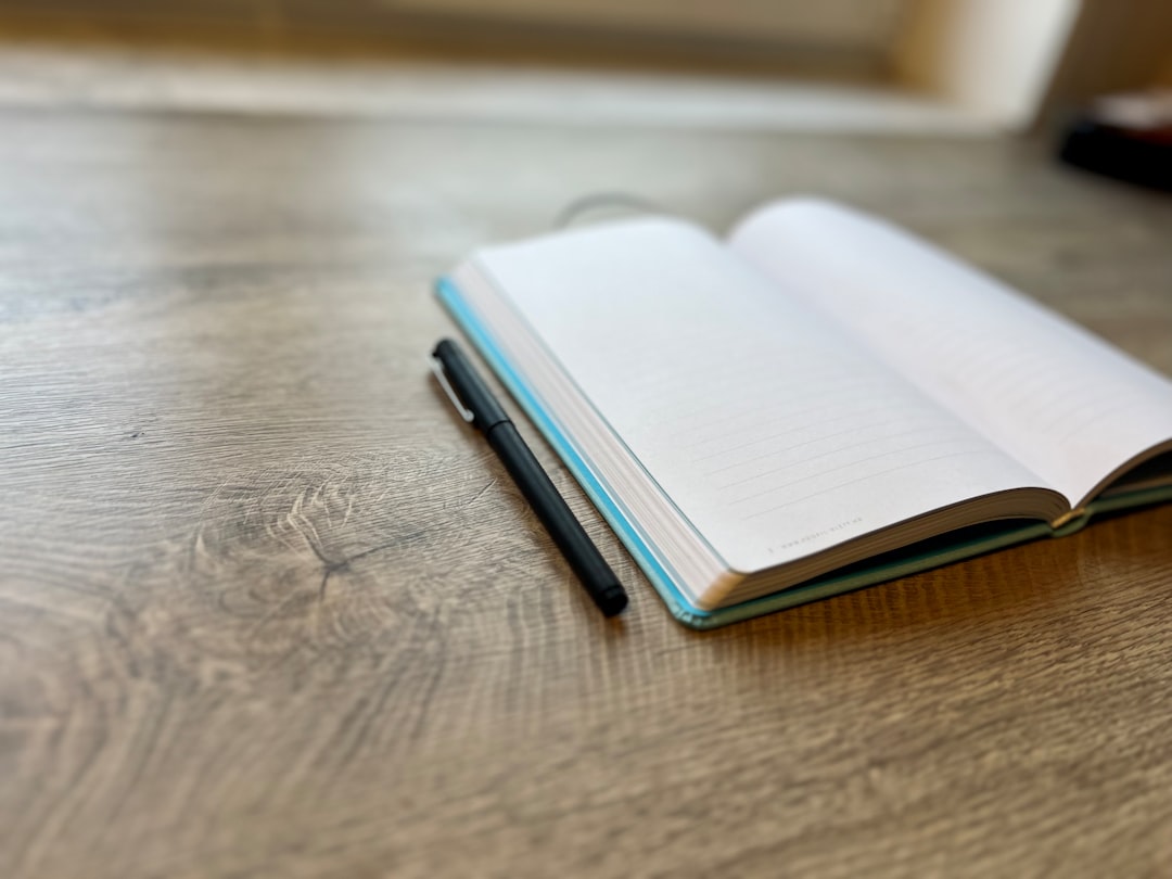 Minimalist clean black notebook and fountain pen on a simple surface, representing the deliberate simplicity and privacy focus of Standard Notes