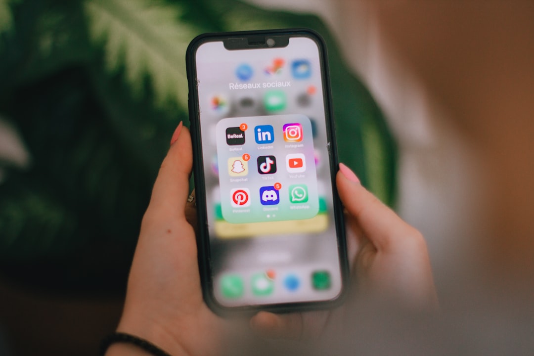 Person looking at a phone screen crowded with productivity app icons, representing the fragmentation that comes from using separate tools for capture, tasks, and notes