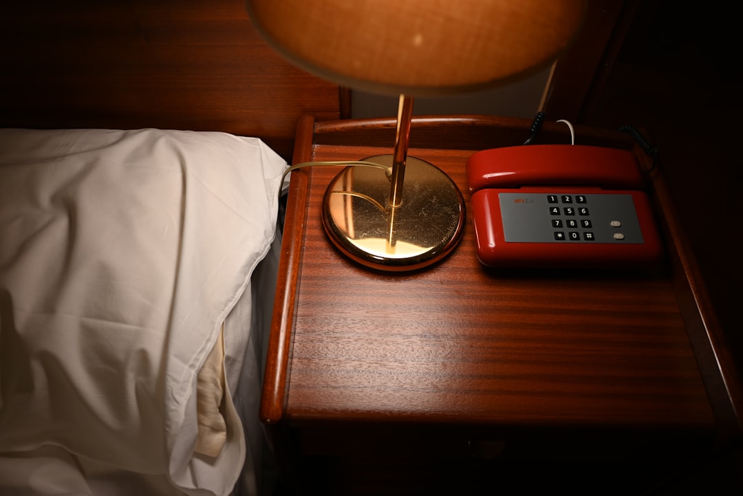 Phone and open notebook on a bedside table for quick capture of ideas