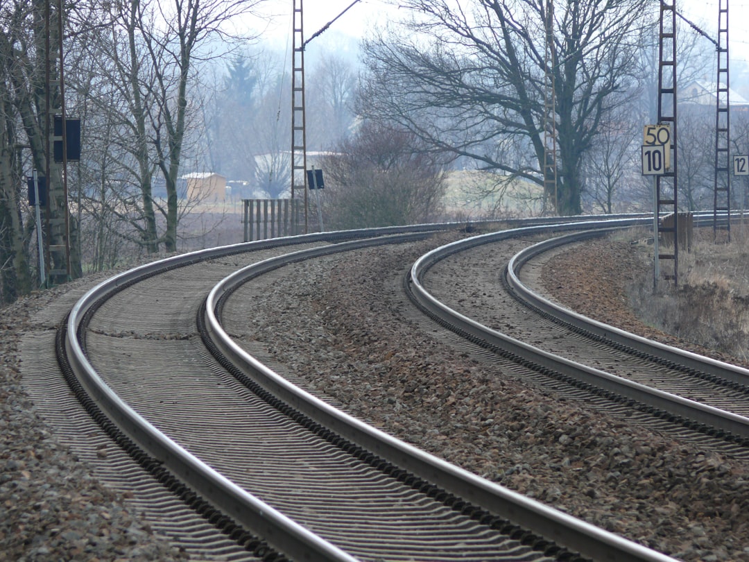 Railway tracks curving through a junction where multiple lines converge and switch