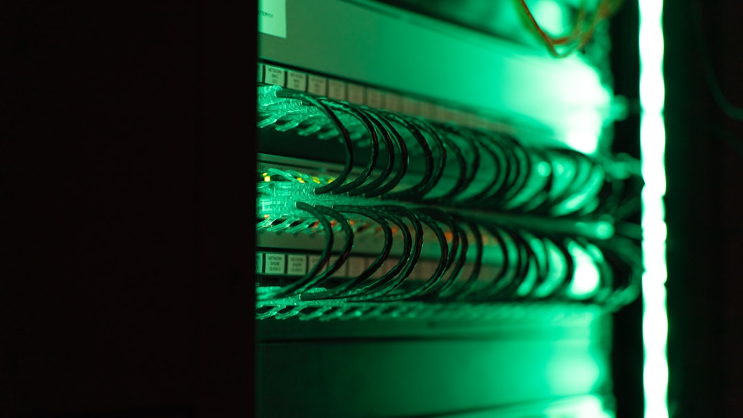 A close-up of a server rack lit in green, representing the compute and storage layer a serverless Postgres database runs on
