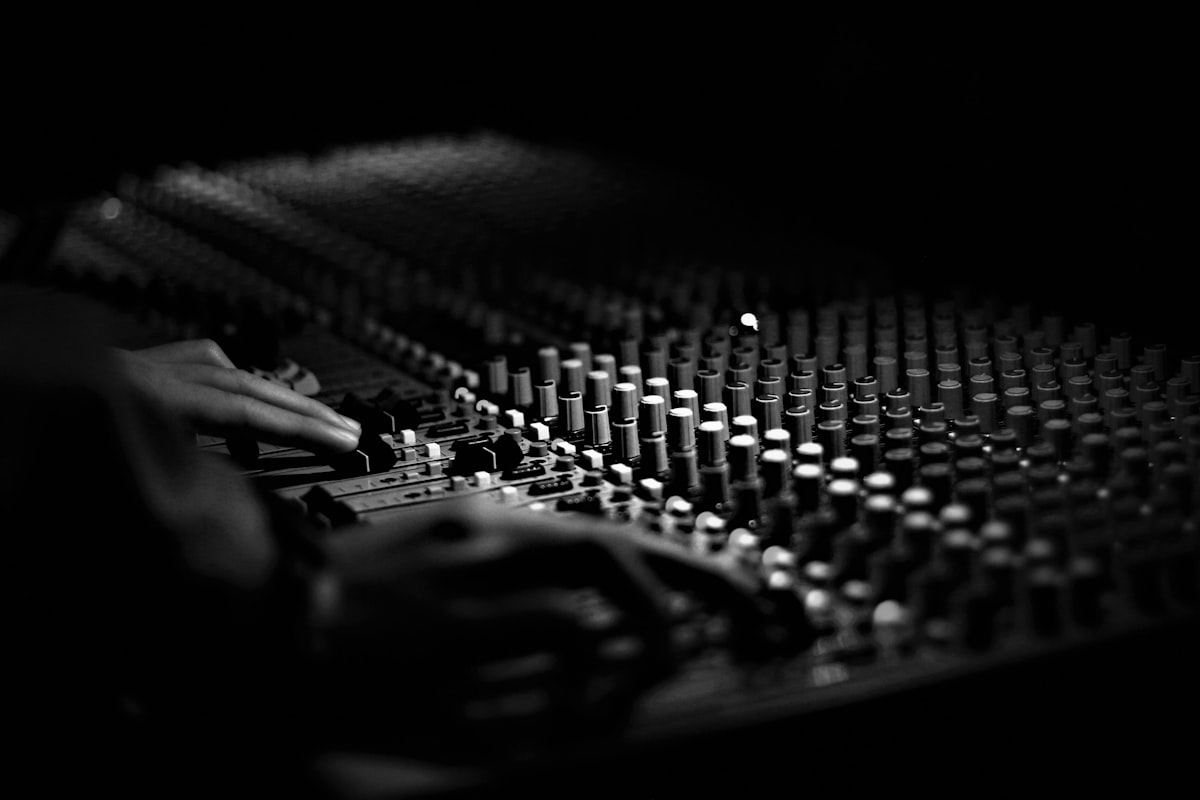 Close-up of an audio mixing console with rows of faders, representing the process of dialing in which connections actually matter