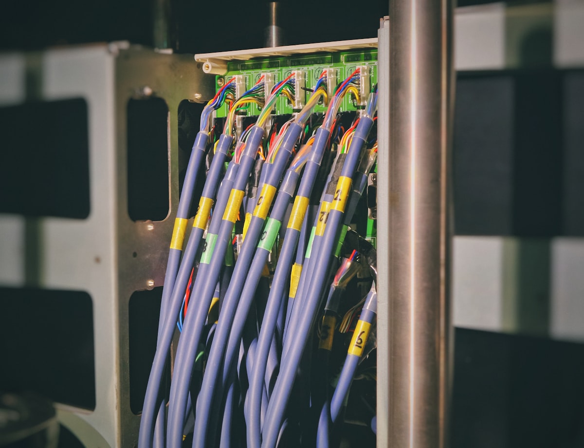 A blue LAN cable plugged into the back of a router, representing a live connection between two systems