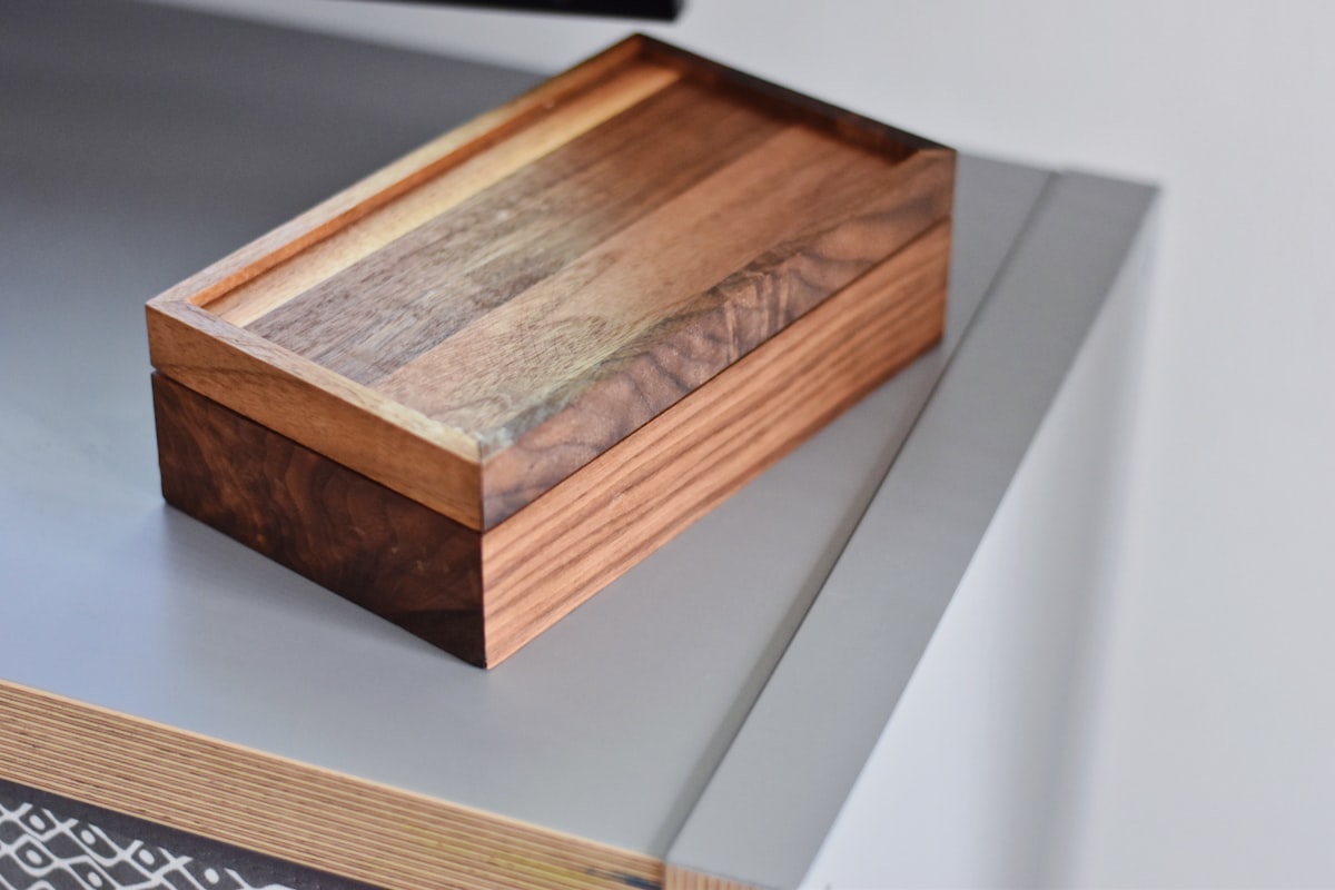 A small wooden box sitting empty on a desk, standing in for an inbox that has actually been cleared