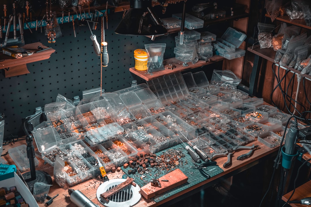 Small parts and components sorted into organizer trays on a workbench