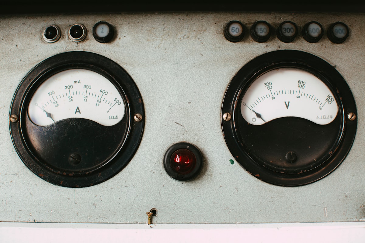 Close-up of an amp and volt analog gauge panel, representing usage-based billing
