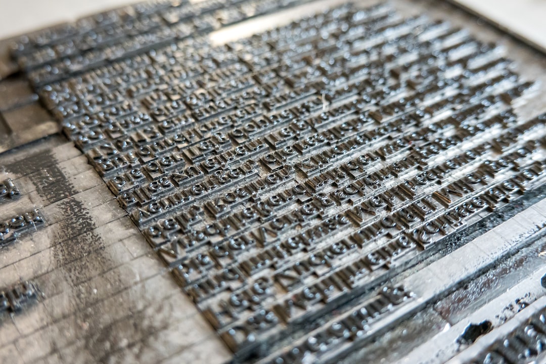 Rows of metal letterpress type arranged in a printing form, representing the deliberate document design Craft is known for