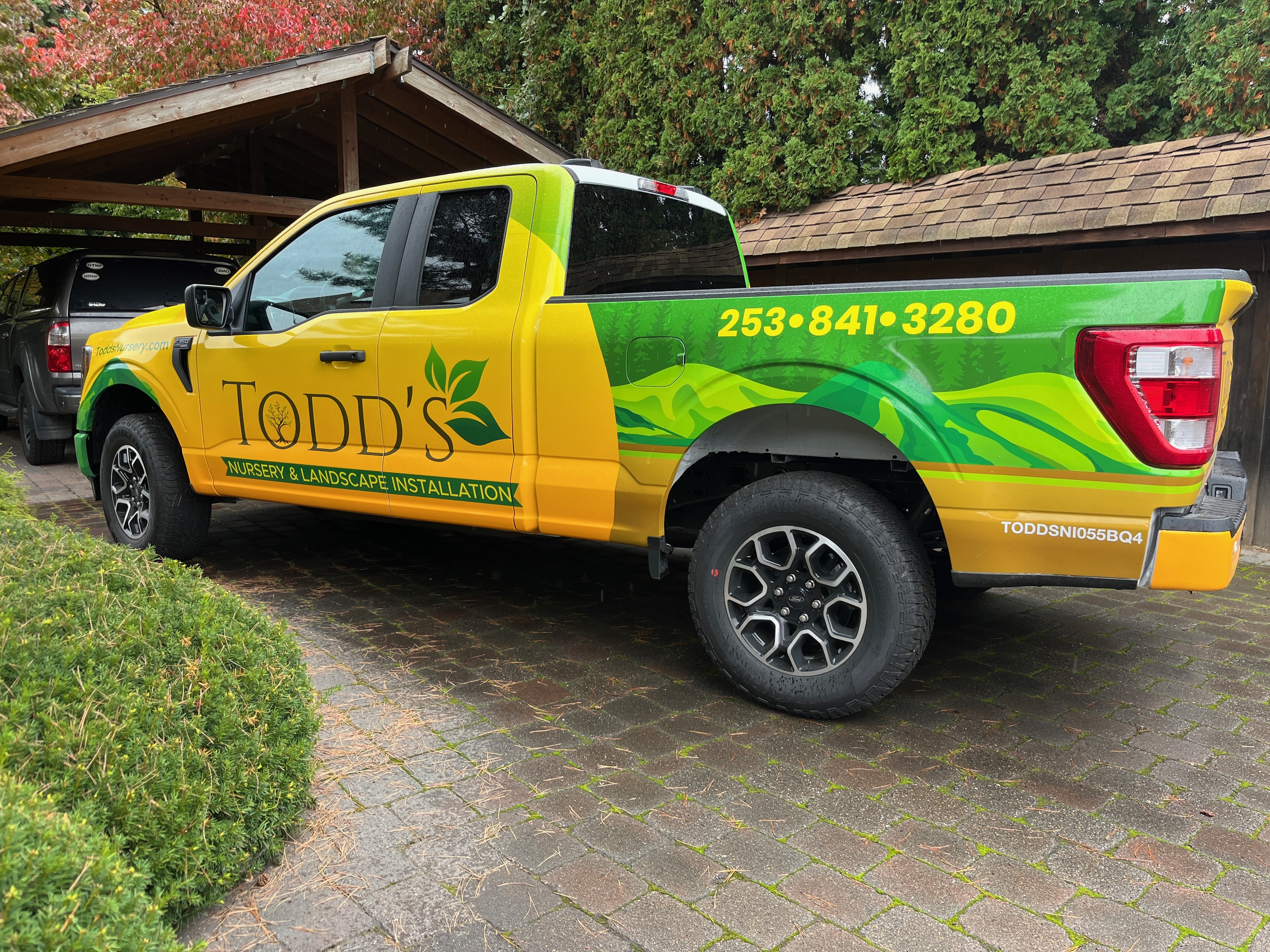 Todd's Nursery landscaping truck parked in Puyallup, WA, showcasing vibrant branding and contact details.
