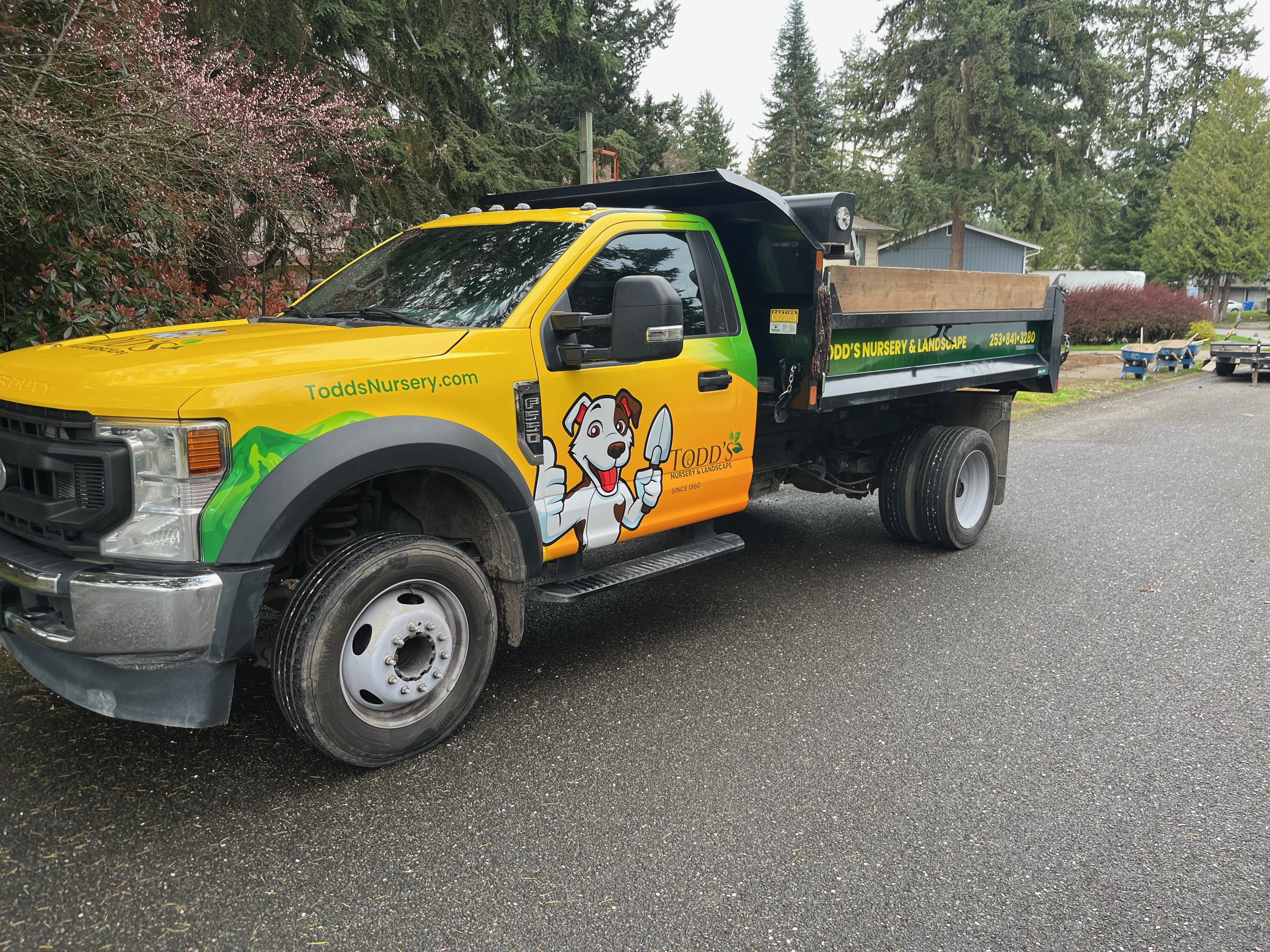 Todd's Nursery landscaping truck parked in Puyallup, WA, surrounded by trees and shrubs.