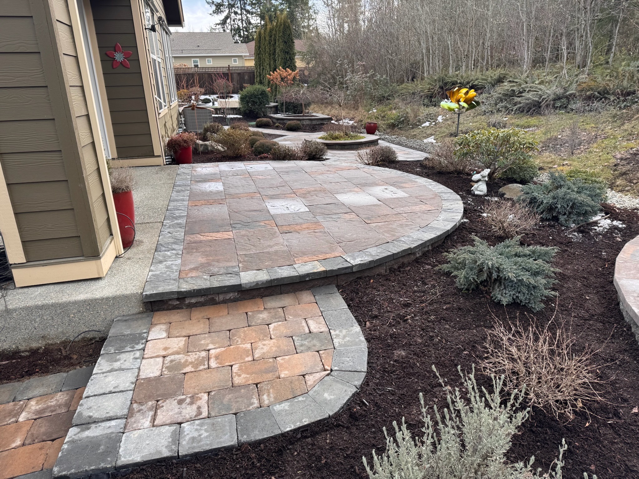 Patio with pavers, retaining wall, shrubs at Todd's Nursery, Puyallup