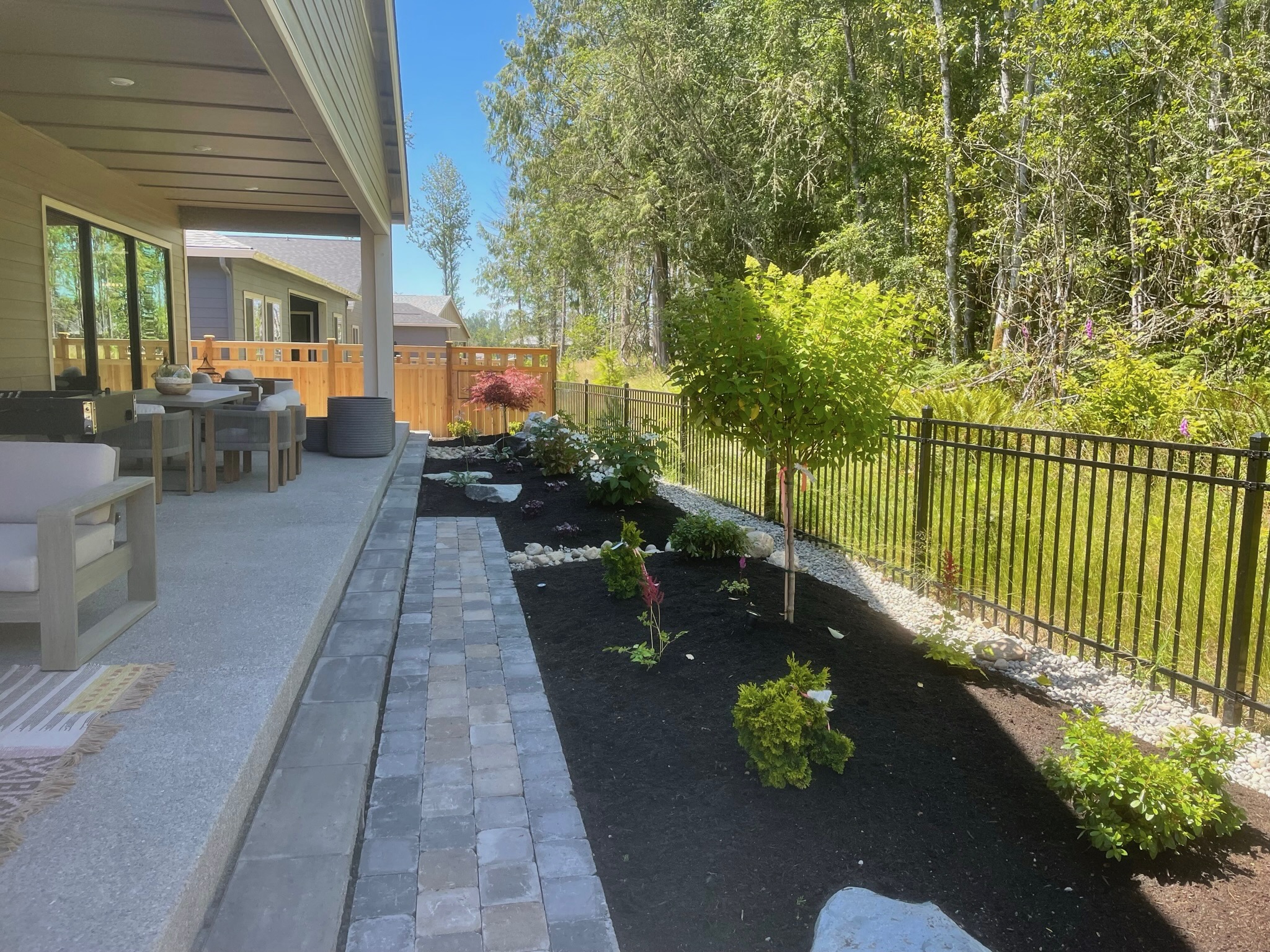 Patio and garden with hydrangeas and trees by Todd's Nursery in Puyallup, WA