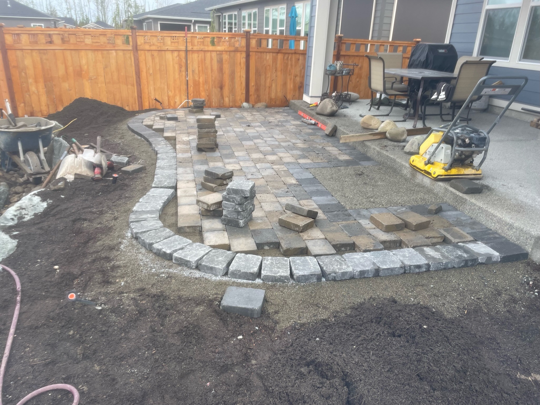 Patio with stone pavers and seating area by Todd's Nursery in Puyallup, WA