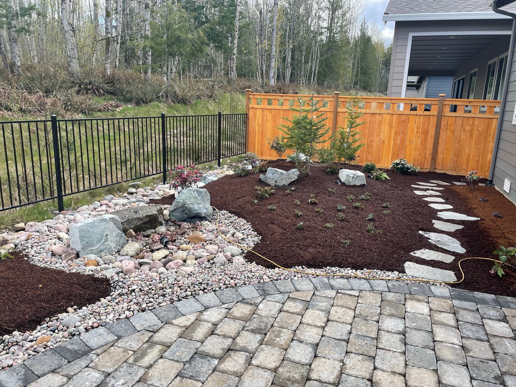 Landscaping by Todd's Nursery in Puyallup with patio, stone path, and water feature