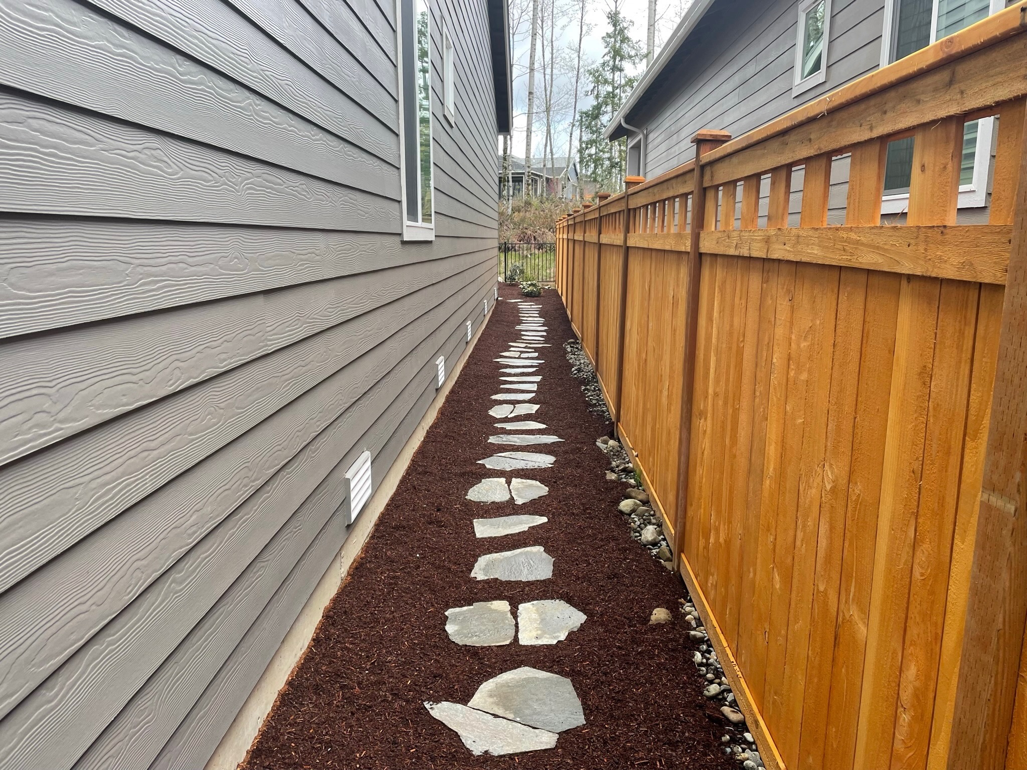 Stone pathway beside cedar fence by Todd's Nursery in Puyallup, WA