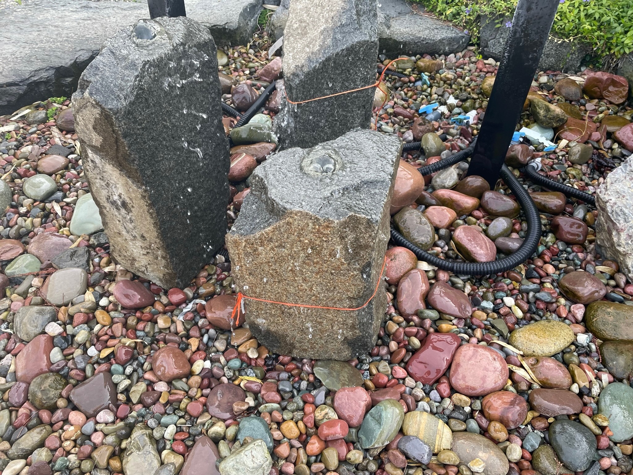 Stone water feature with colorful pebbles at Todd's Nursery in Puyallup, WA.