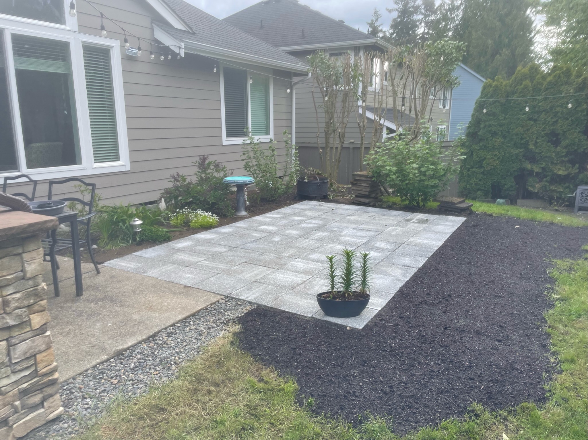 Modern patio with pavers, garden plants, and mulch by Todd's Nursery in Puyallup, WA