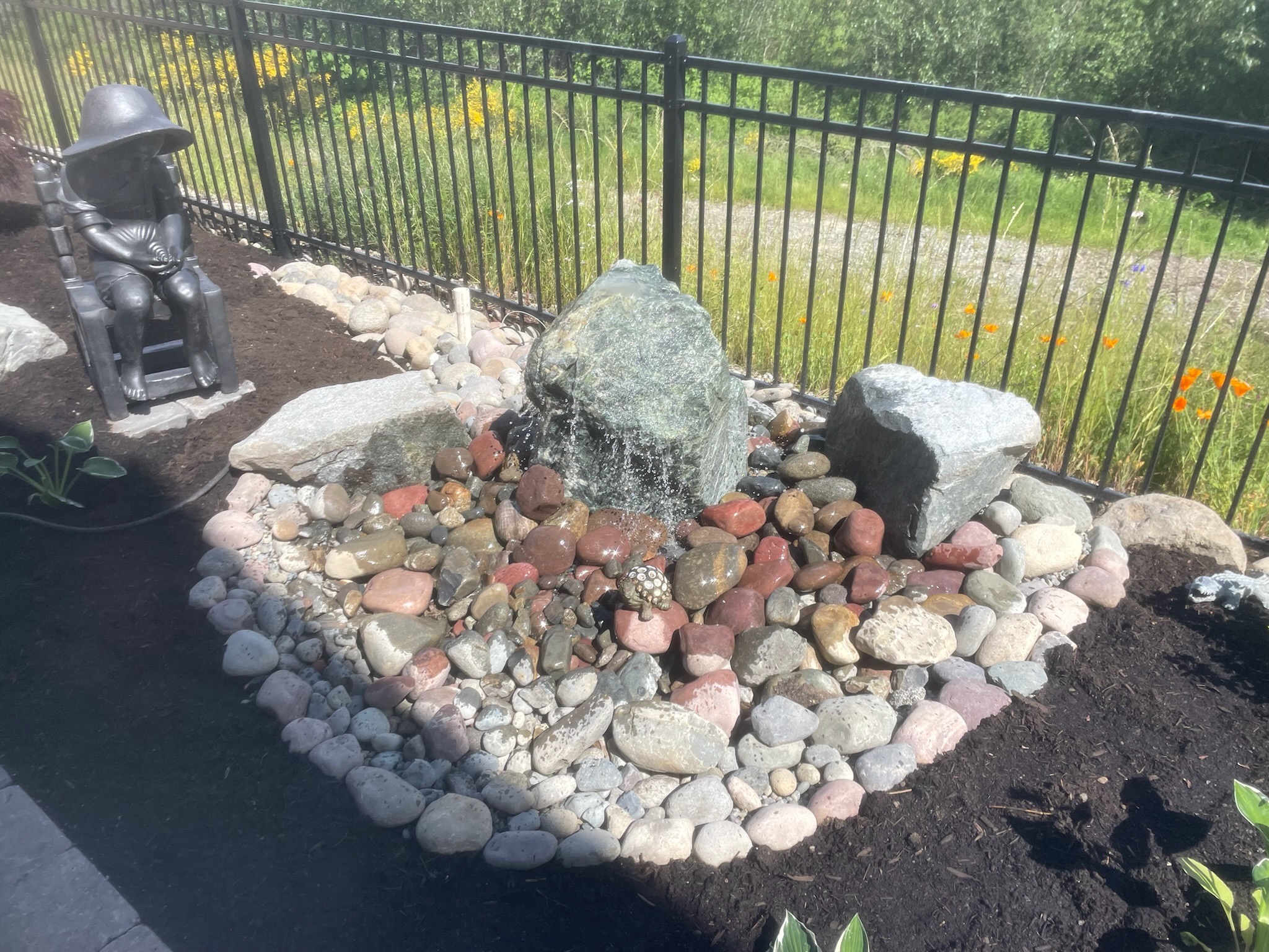 Garden water feature with stones and statue at Todd's Nursery, Puyallup, WA