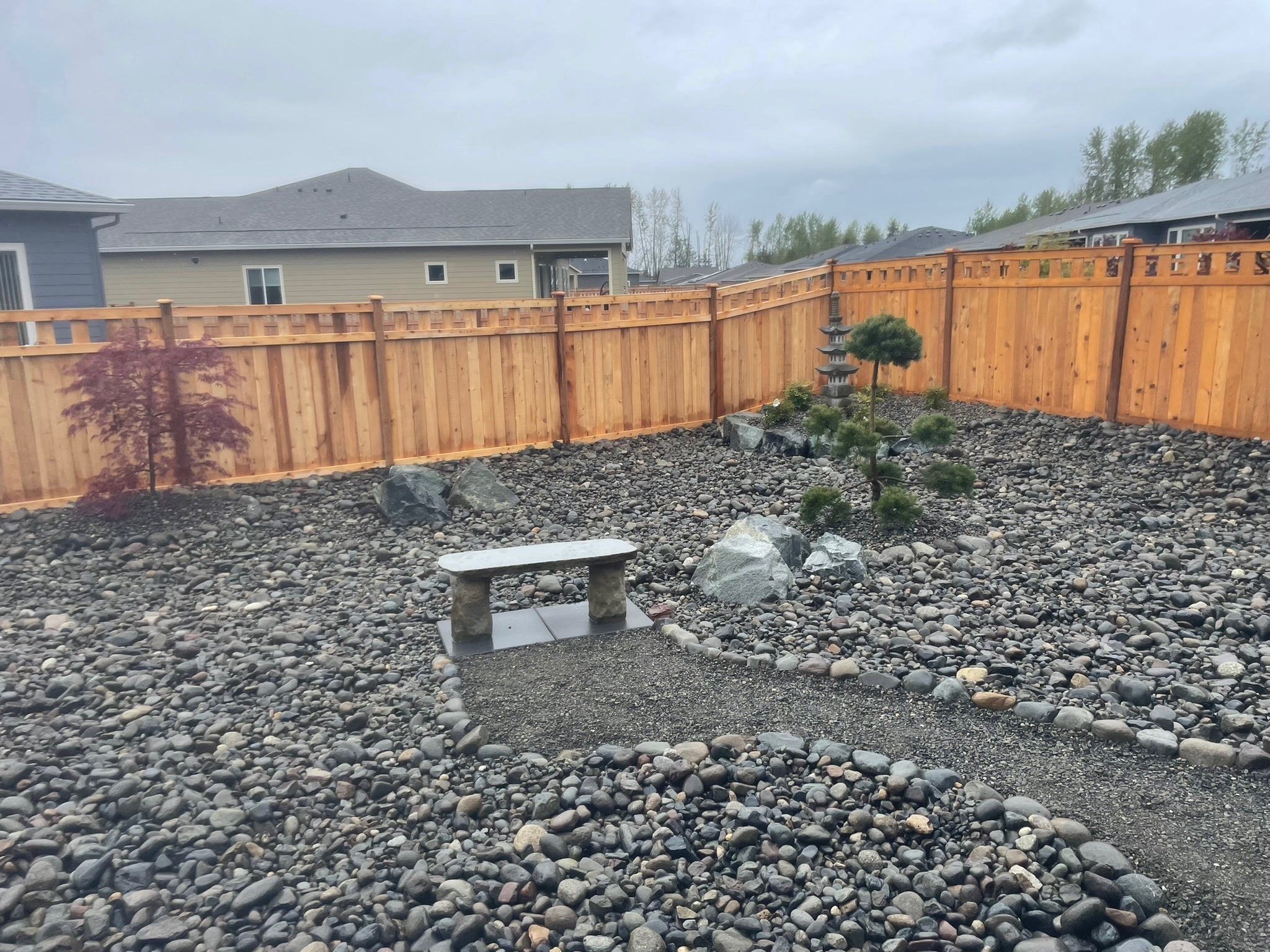 Zen garden at Todd's Nursery in Puyallup, WA featuring a stone bench, pagoda, and Japanese maple.