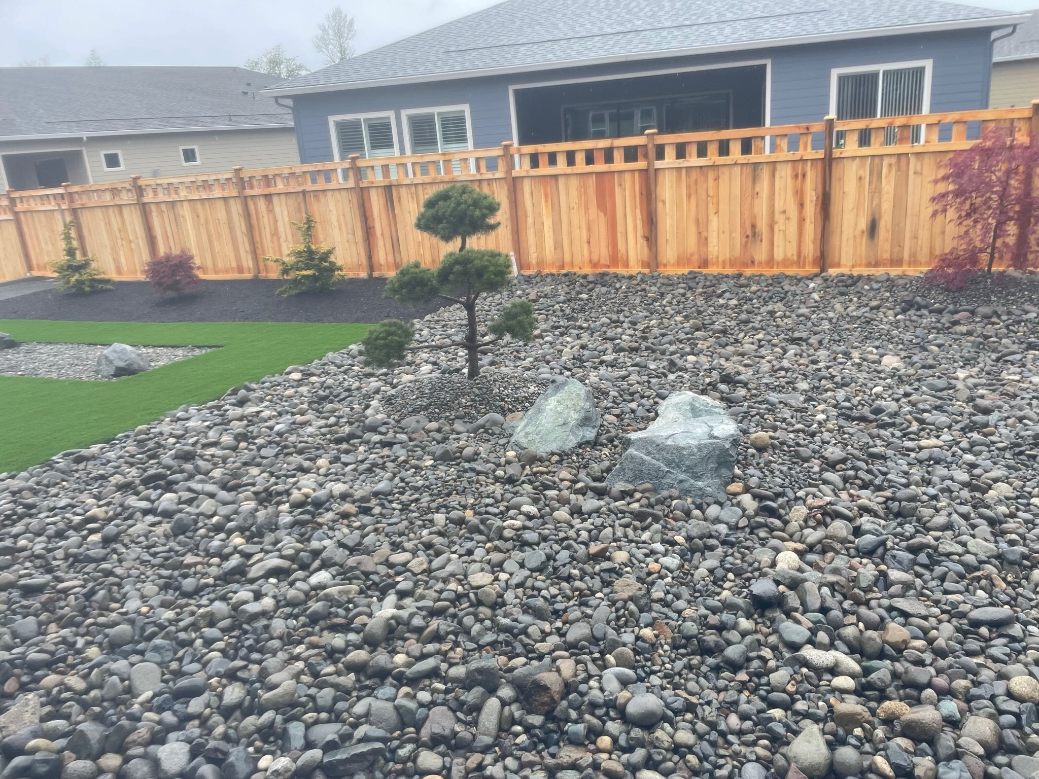 Zen garden with stones, Japanese maples, and conifers by Todd's Nursery in Puyallup, WA