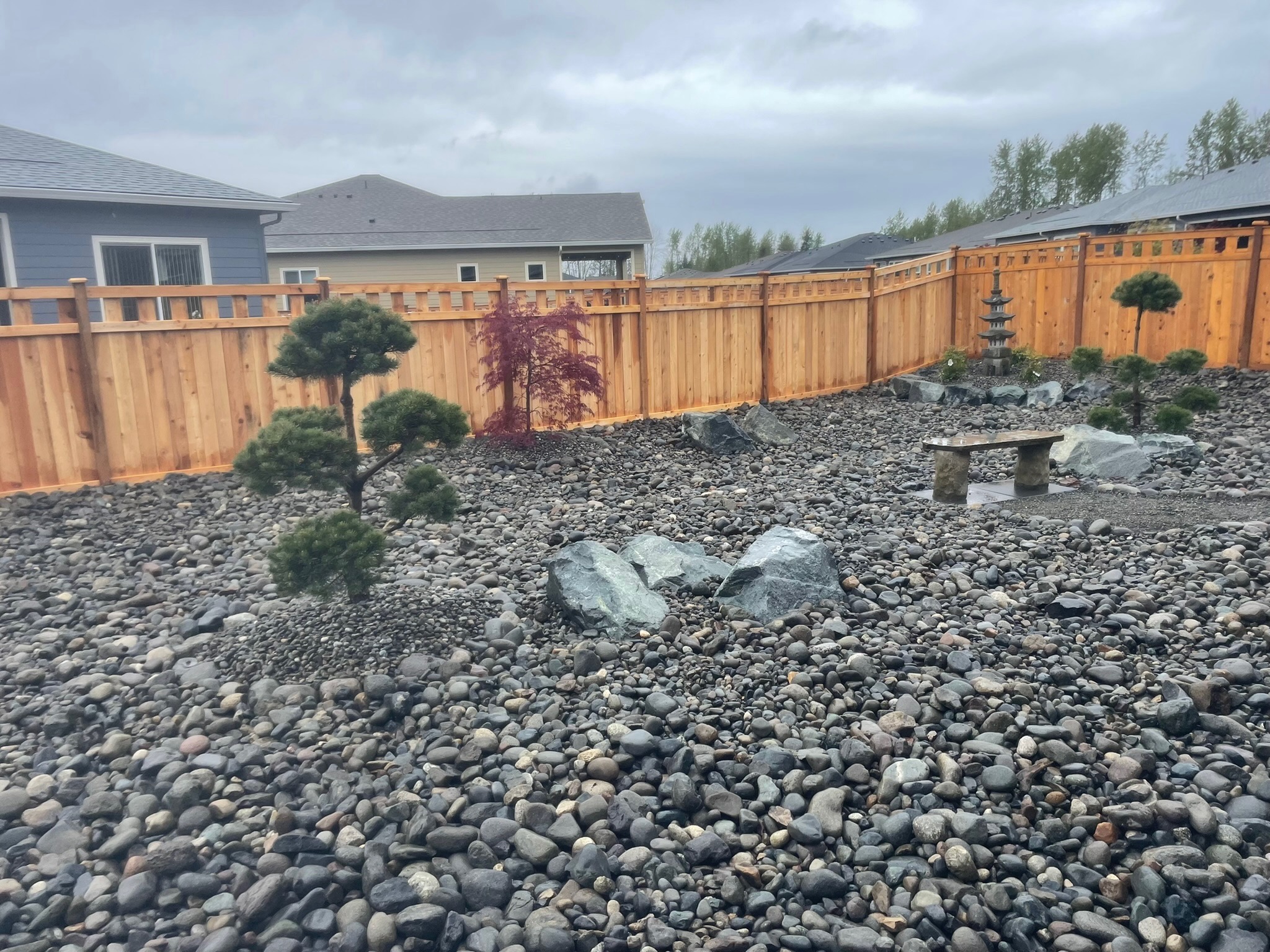 Zen garden with stone lantern, Japanese maples, and rocks by Todd's Nursery in Puyallup, WA