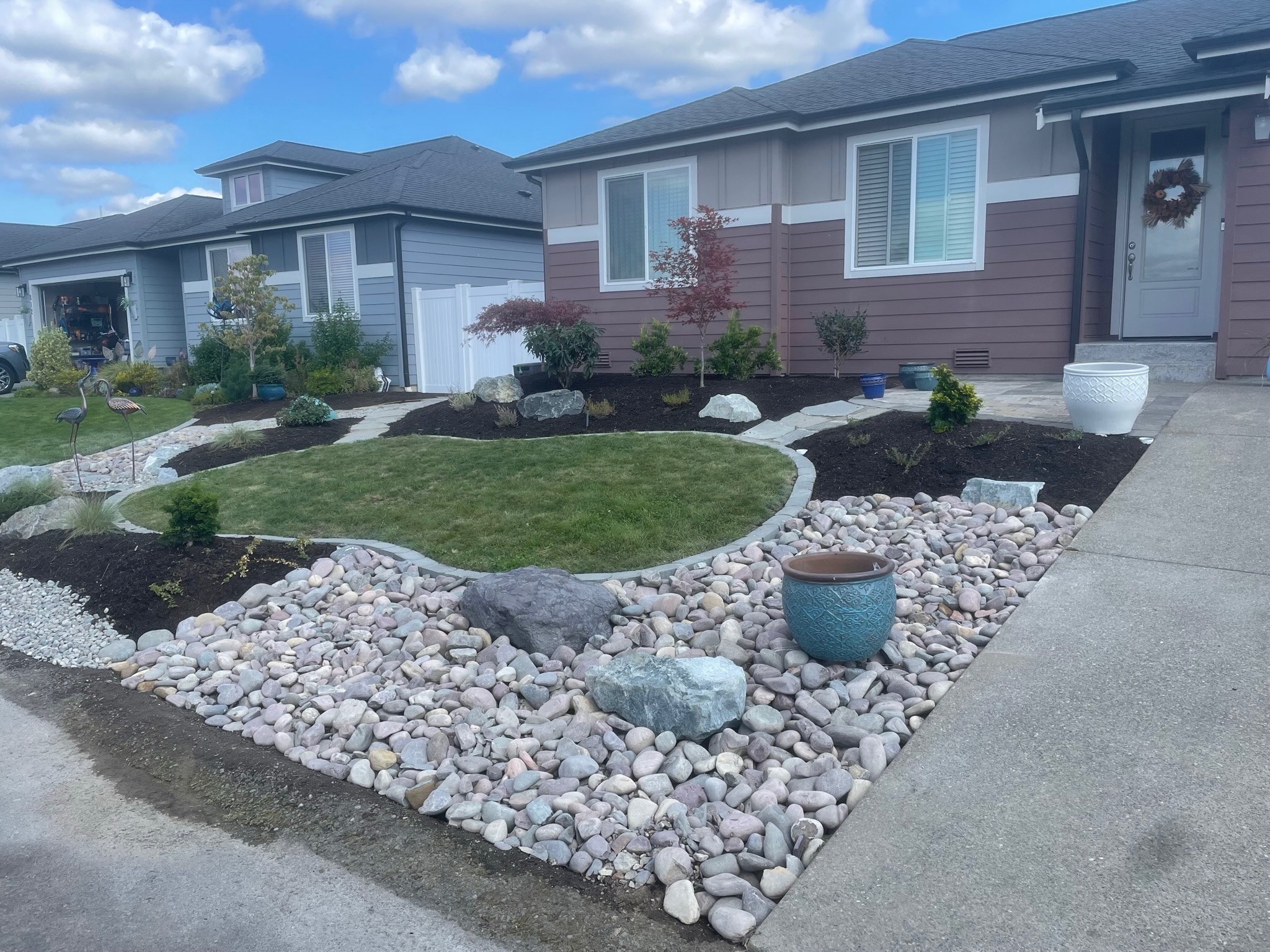 Front yard with stone pathway, colorful plants, and rock garden by Todd's Nursery in Puyallup, WA.