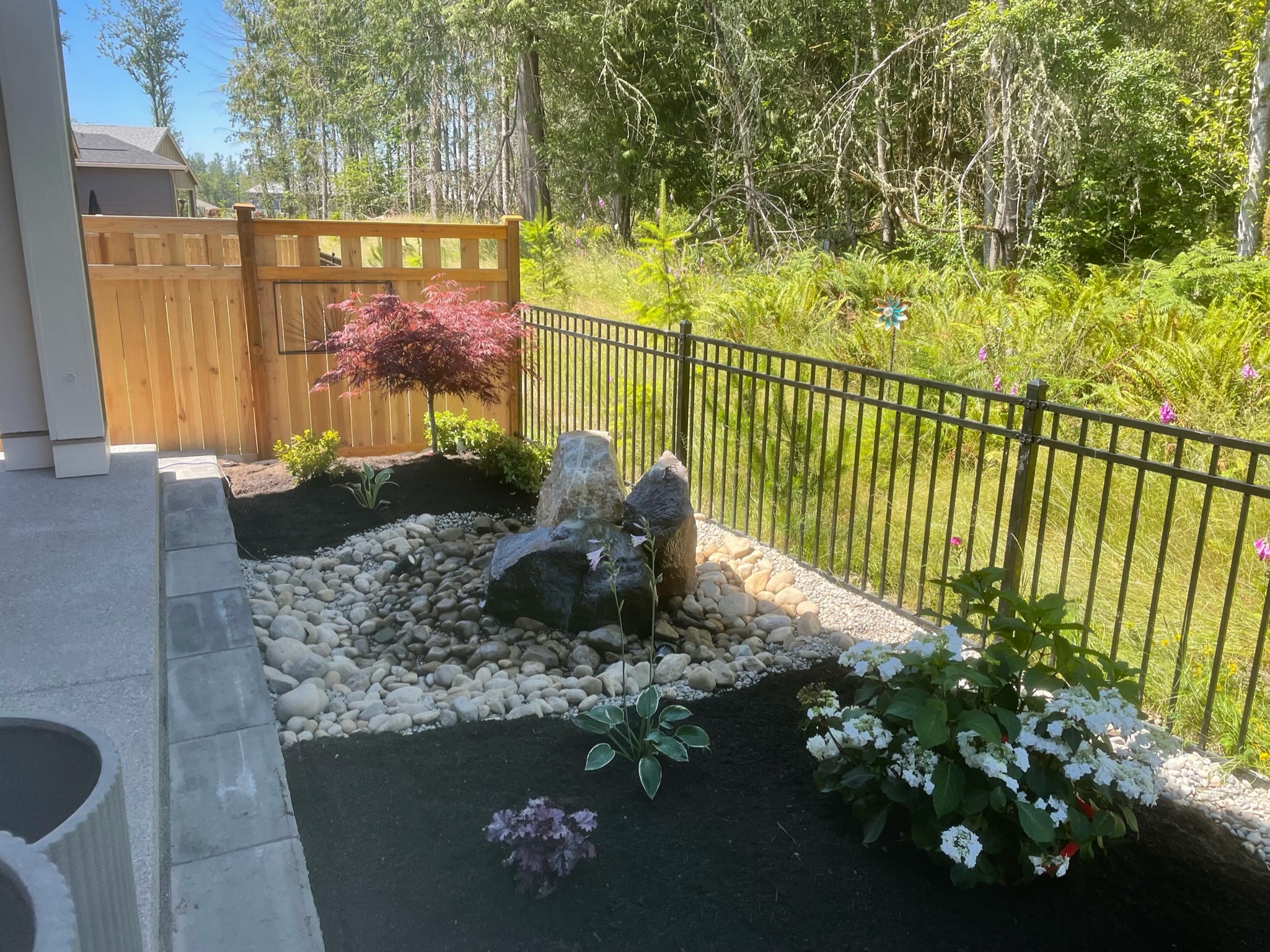 Garden with water feature, Japanese maple, hydrangeas at Todd's Nursery, Puyallup, WA