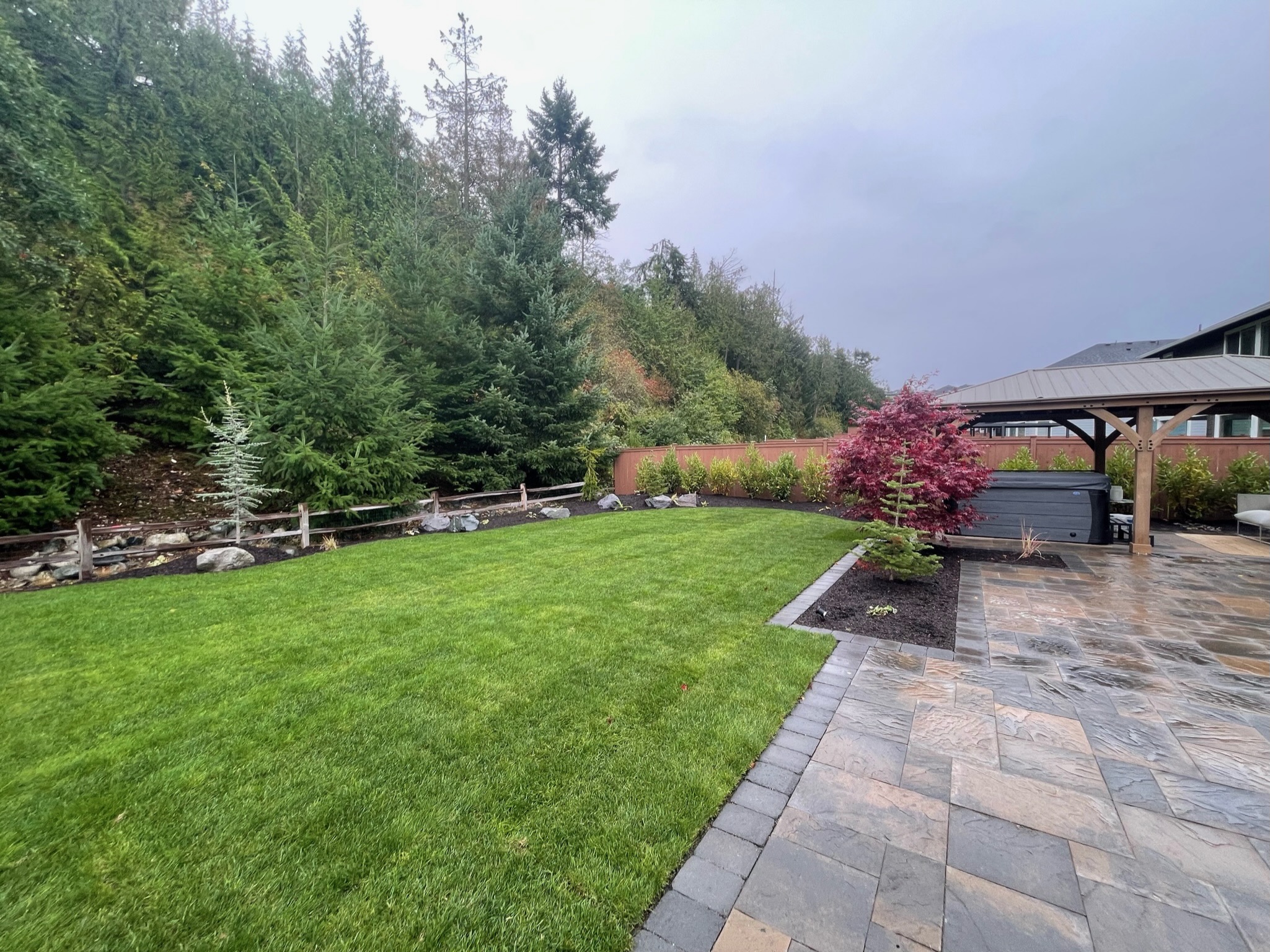 Landscaped patio with Japanese Maple, gazebo, and lush lawn by Todd's Nursery in Puyallup, WA