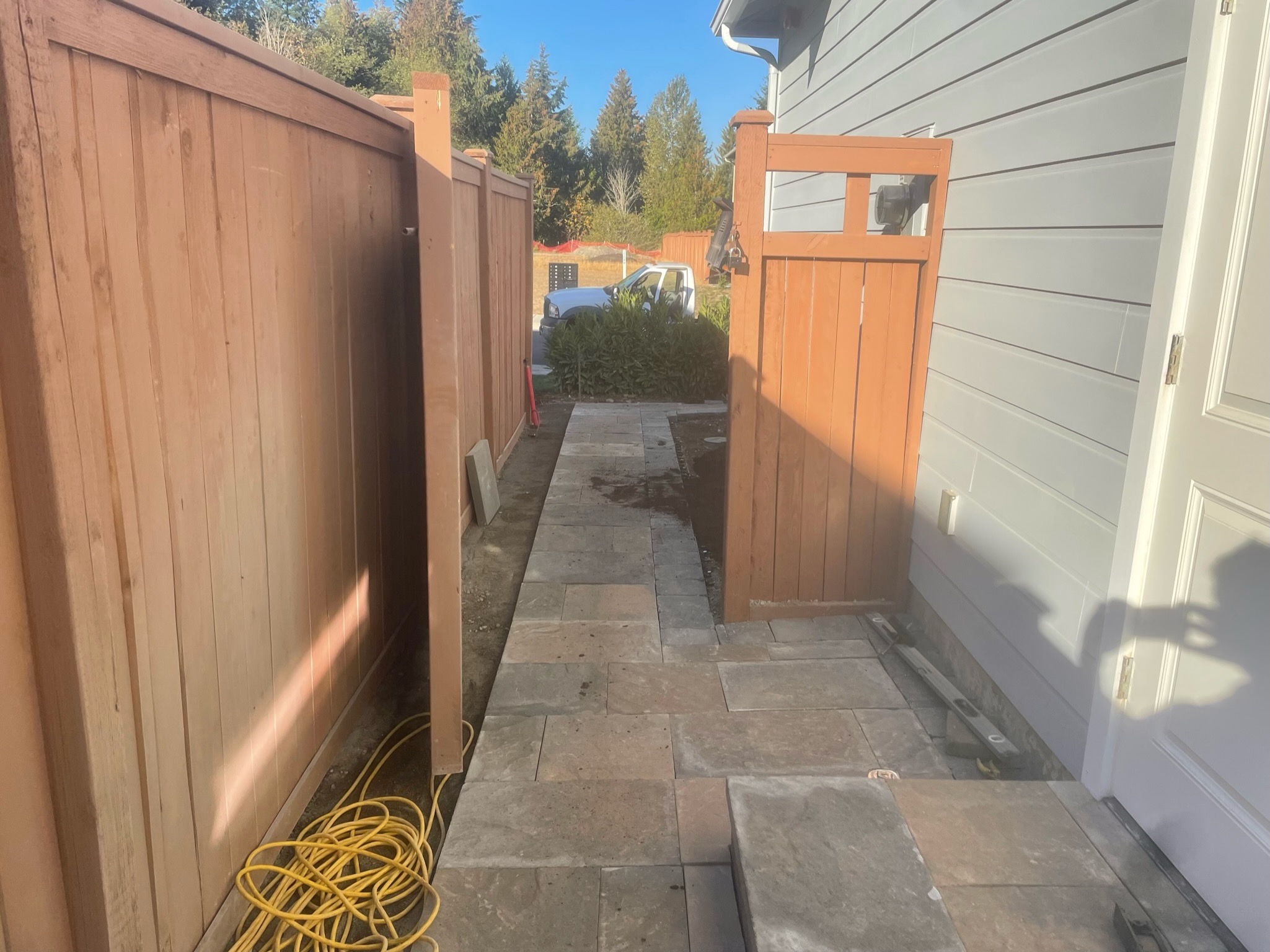 Stone patio with wooden fence by Todd's Nursery in Puyallup, WA