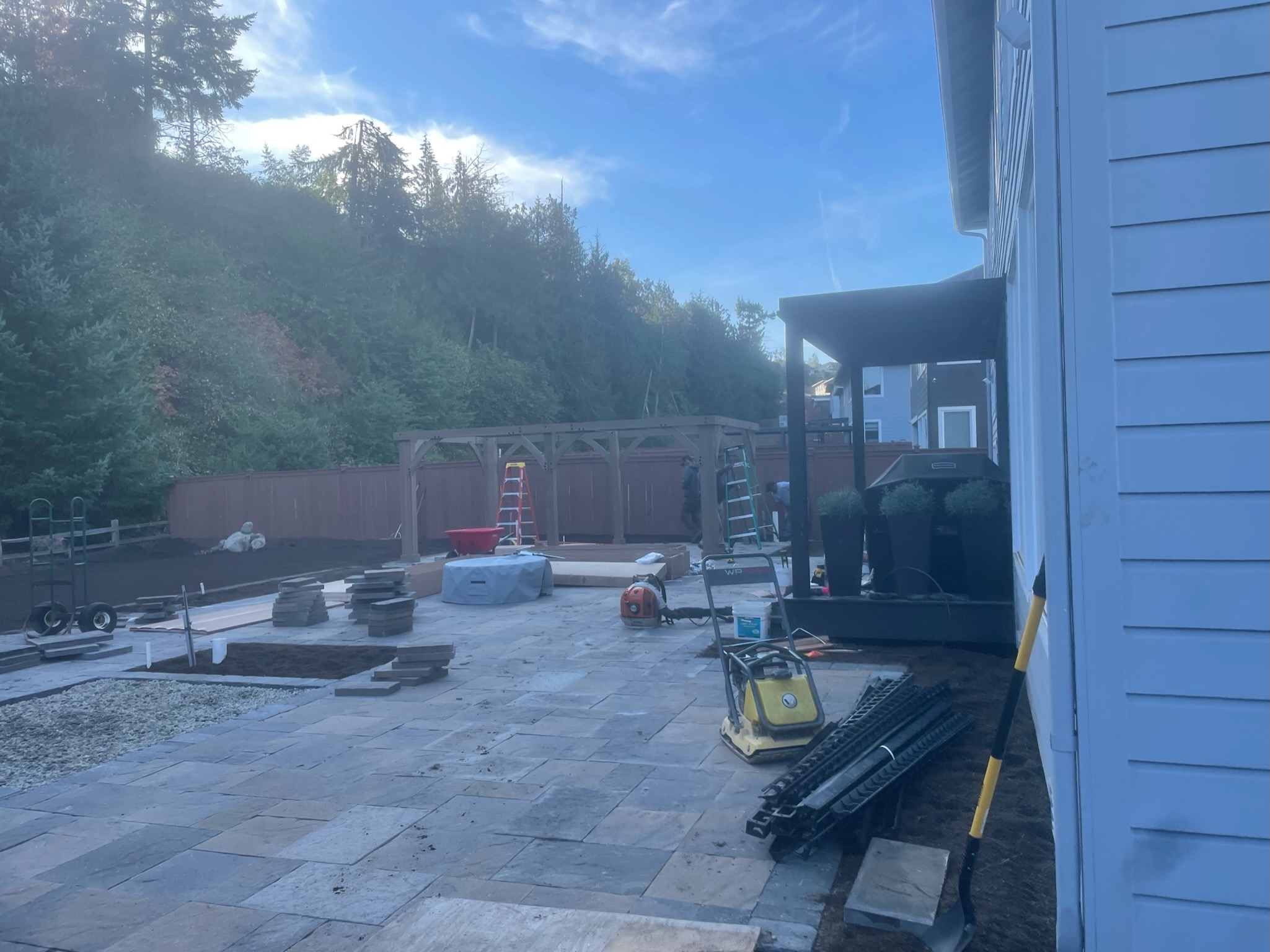 Patio with stone pavers and pergola by Todd's Nursery in Puyallup, WA