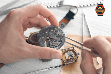 Watchmaker carefully servicing a vintage movement.