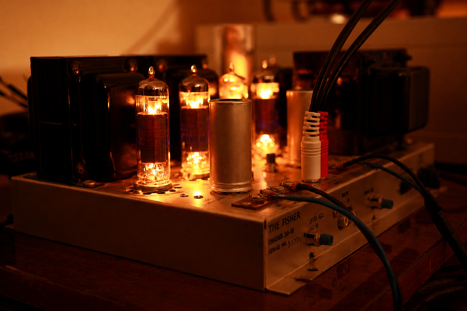 Vintage tube amplifier with glowing vacuum tubes, audio equipment, hi-fi, stereo, retro electronics, warm orange light, close-up view.