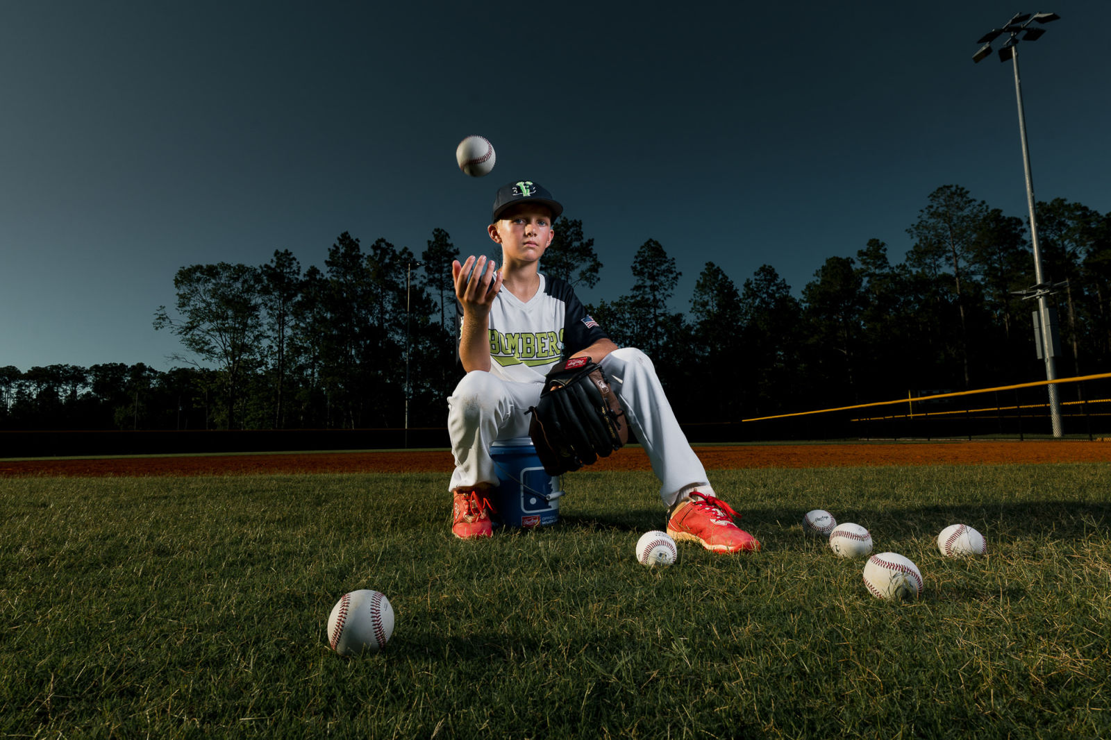 Athlete portrait framed by rim light and smoke.