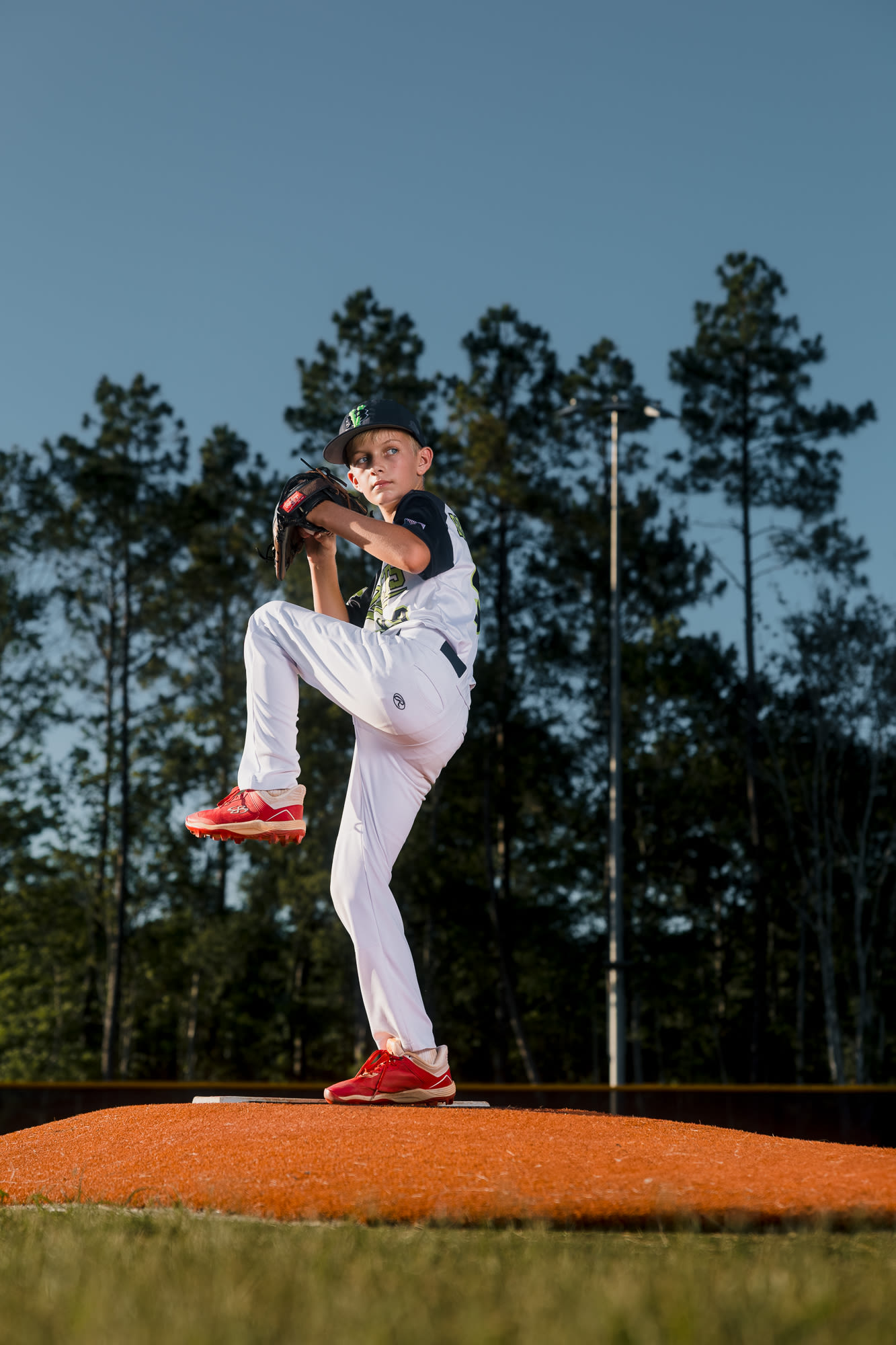 Athlete tossing a ball with streaking shutter drag.